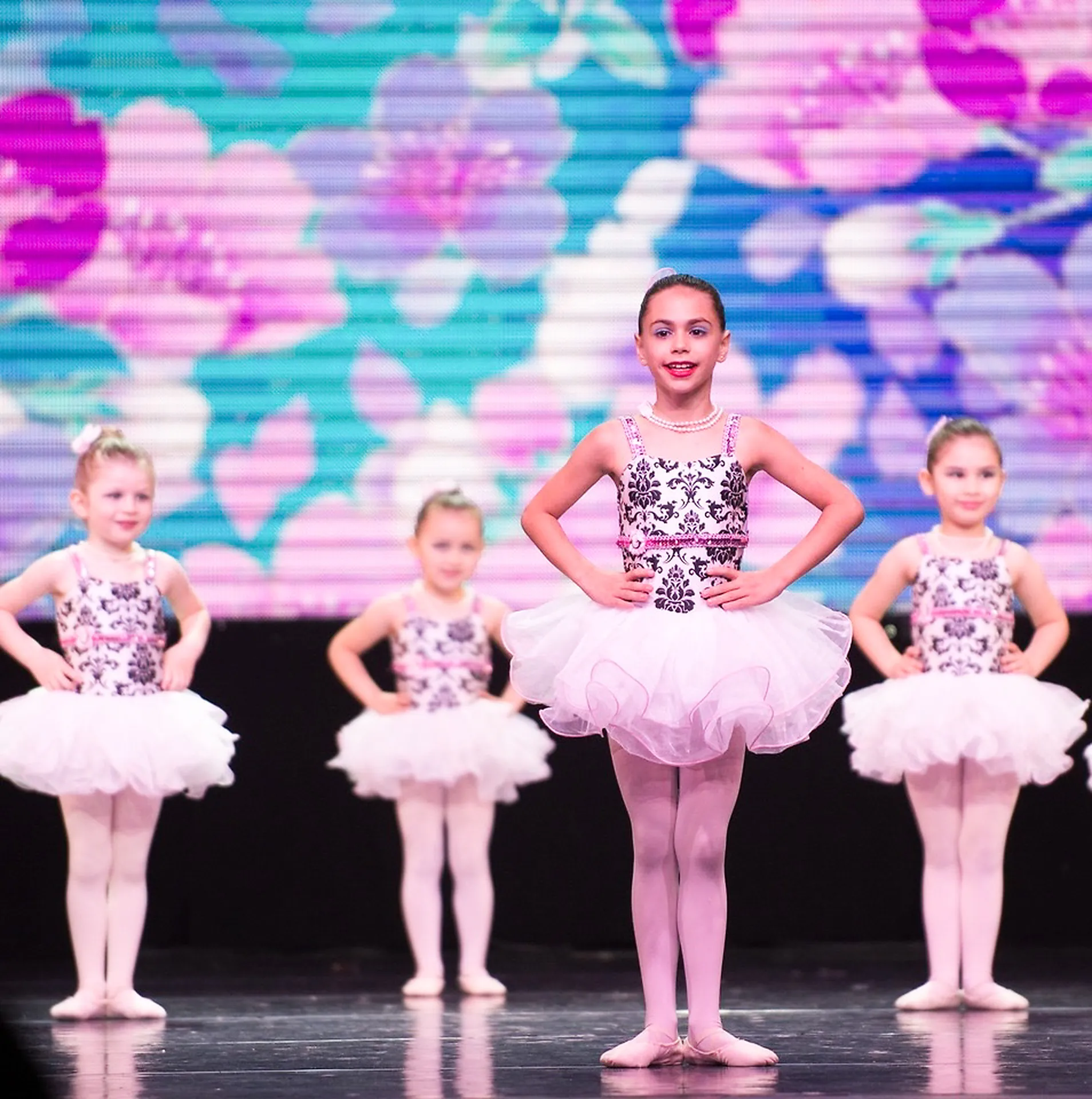 Young Nika dancers in white tutus on stage