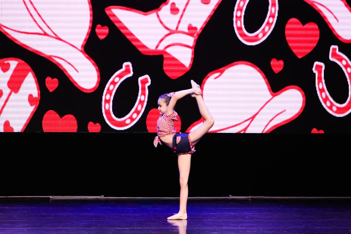 A gymnastics student performing on stage
