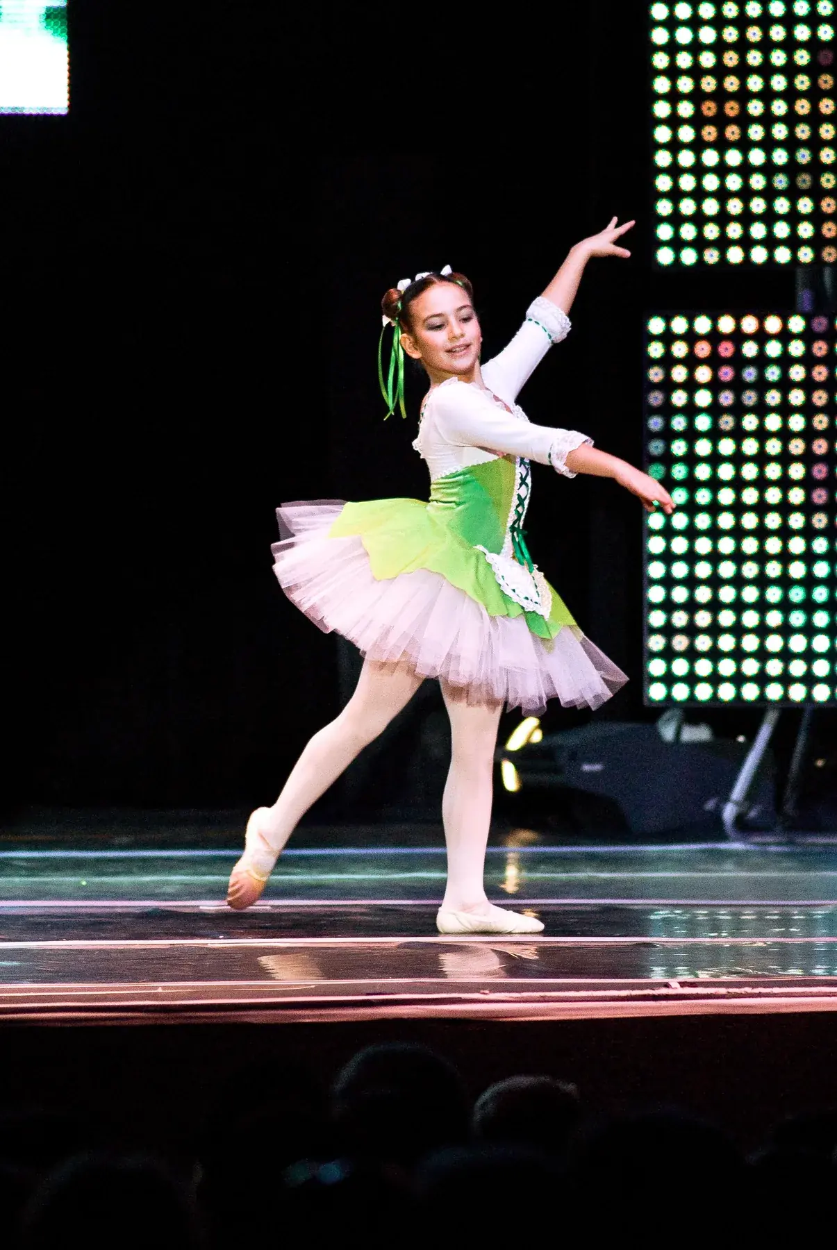 A young ballet dancer performing on stage