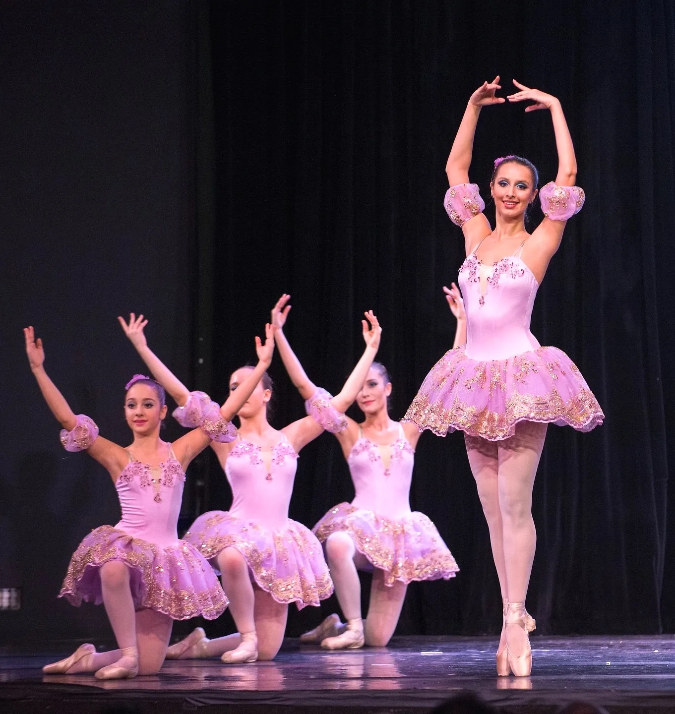 Four Nika dancers in pink tutus on stage