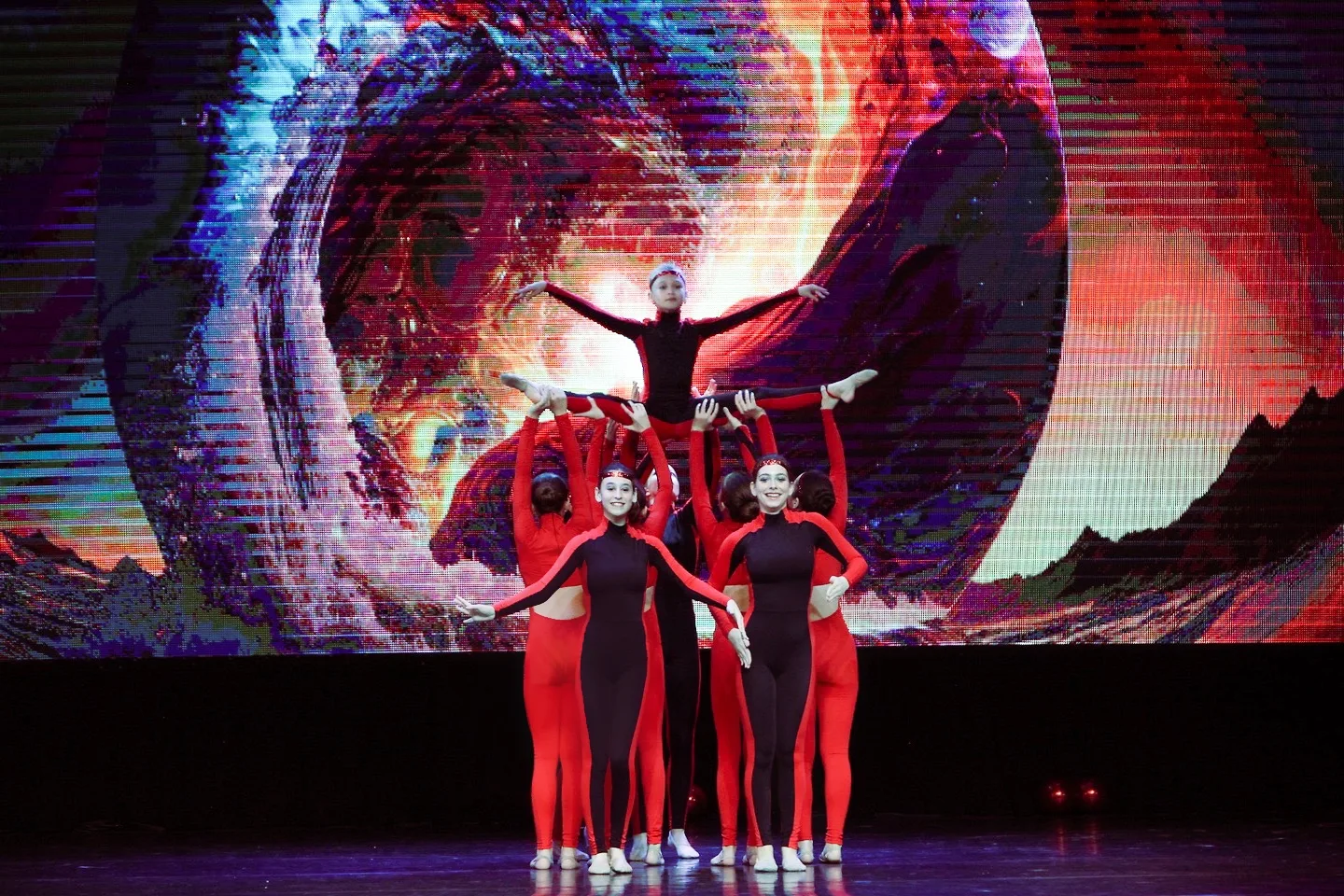 Nika gymnasts in a group formation on stage