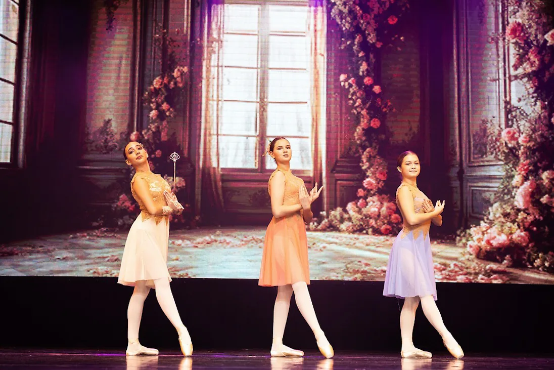 Dancers performing a classical variation on stage